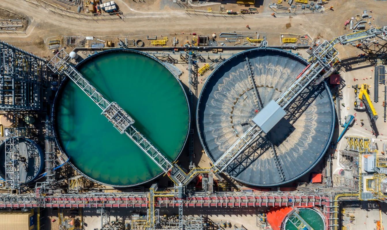 Aerial view of QB2 copper mine, including two large tanks.