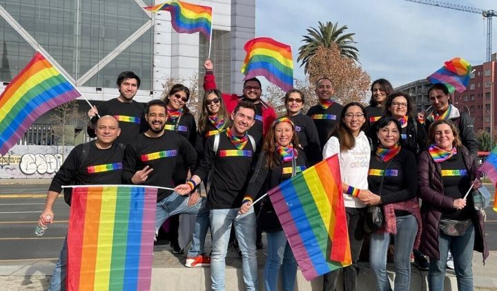 Bechtel team members waving rainbow pride flags.