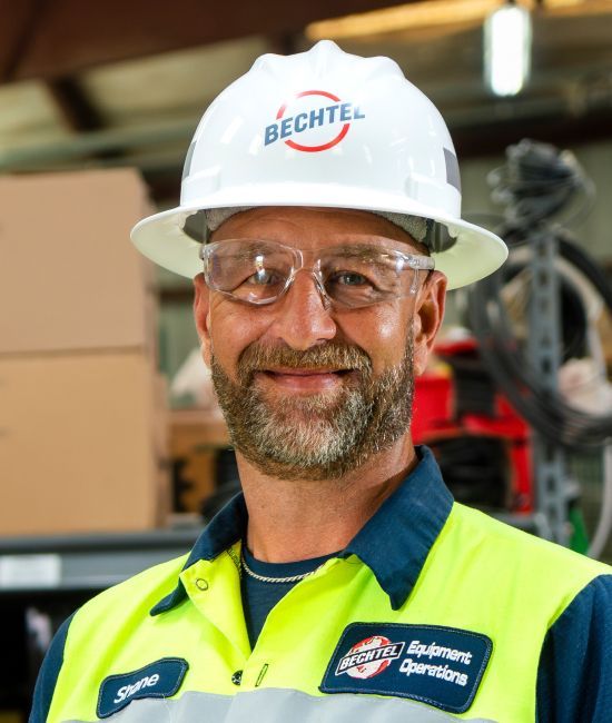 A Bechtel Equipment Operations team member wearing a hard hat and safety goggles.