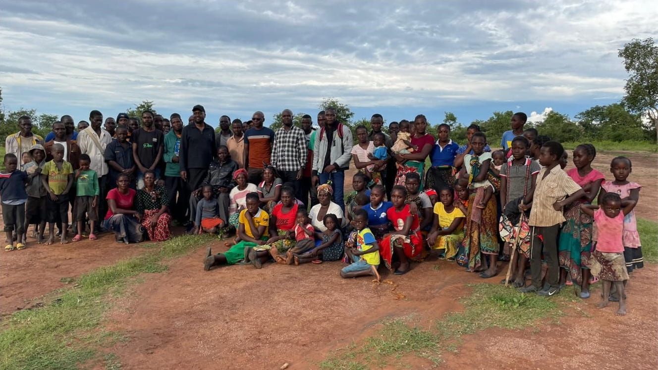 A group of adults and children, including locals, in Zambia.