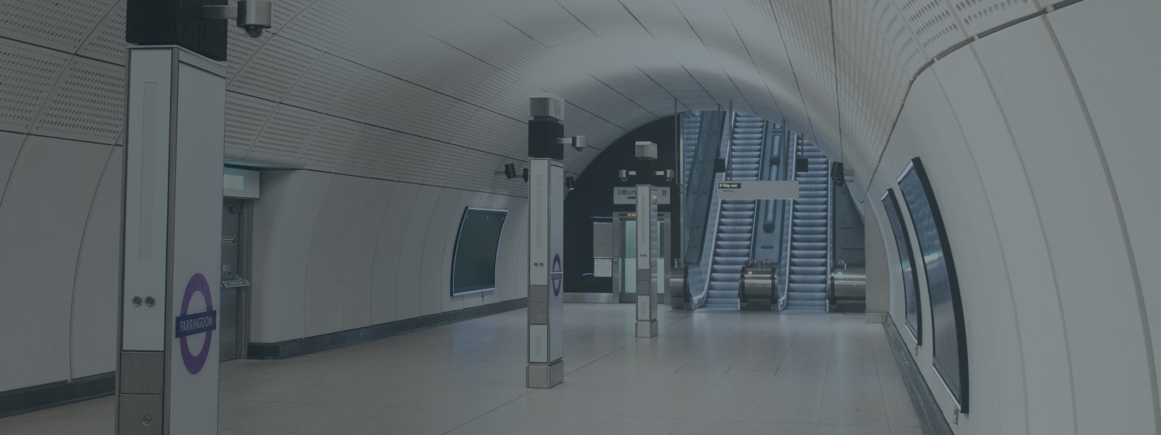 A bright subway station with a staircase at the end.