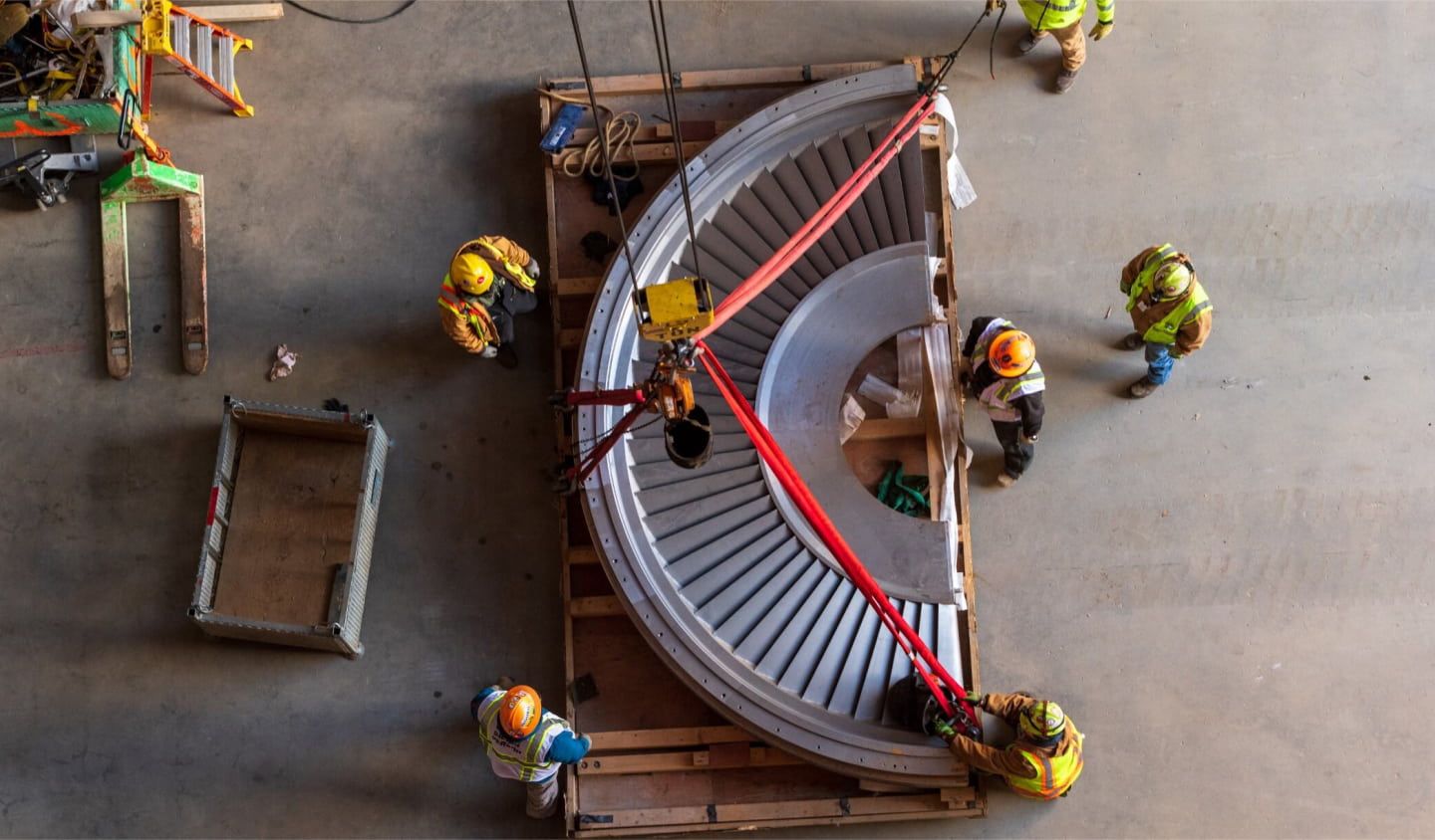 People maneuvering a large piece of equipment at Vogtle nuclear power plant.