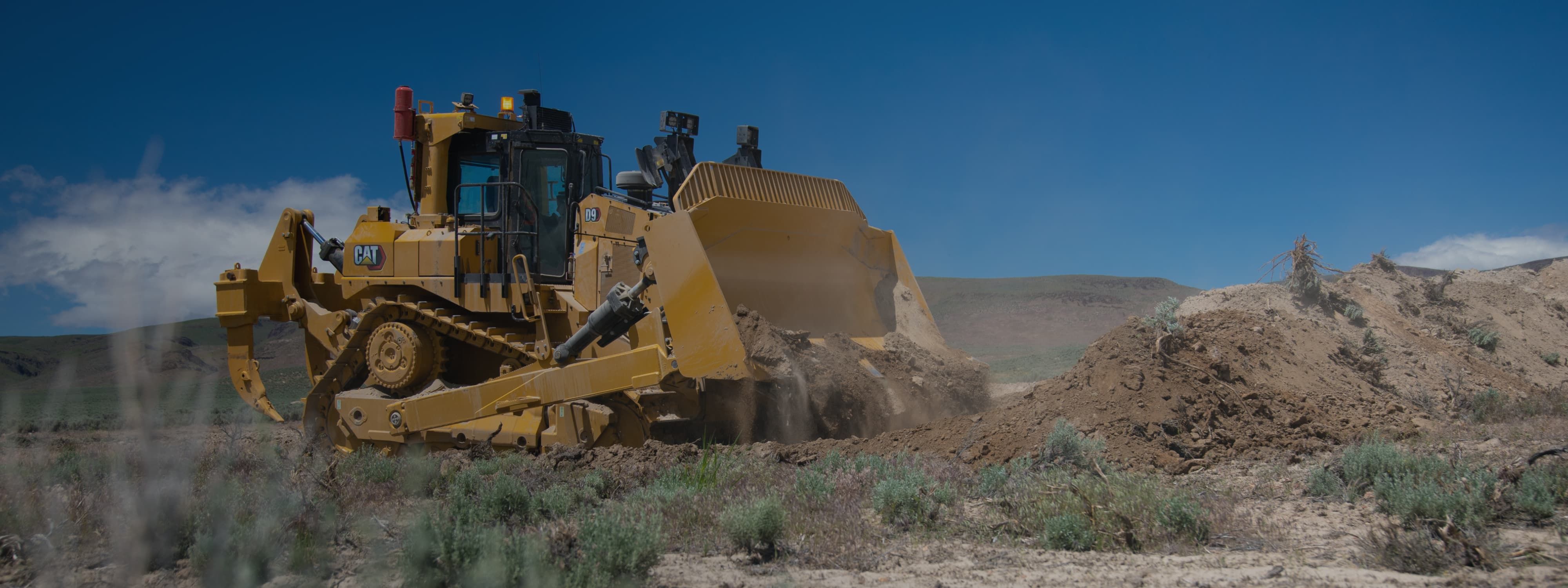 A bulldozer piling up dirt.